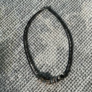 Charm necklace with black leather cord